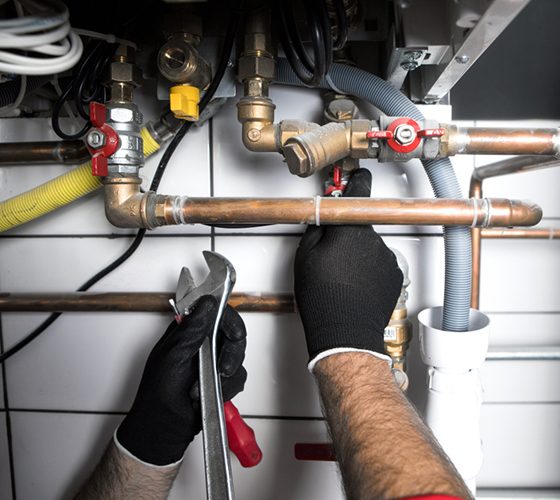 Plumber fixing drainage pipe — Plumbing & Gas Fitting in Coffs Harbour, NSW